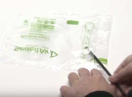 Insert a straw or tube through the flap
